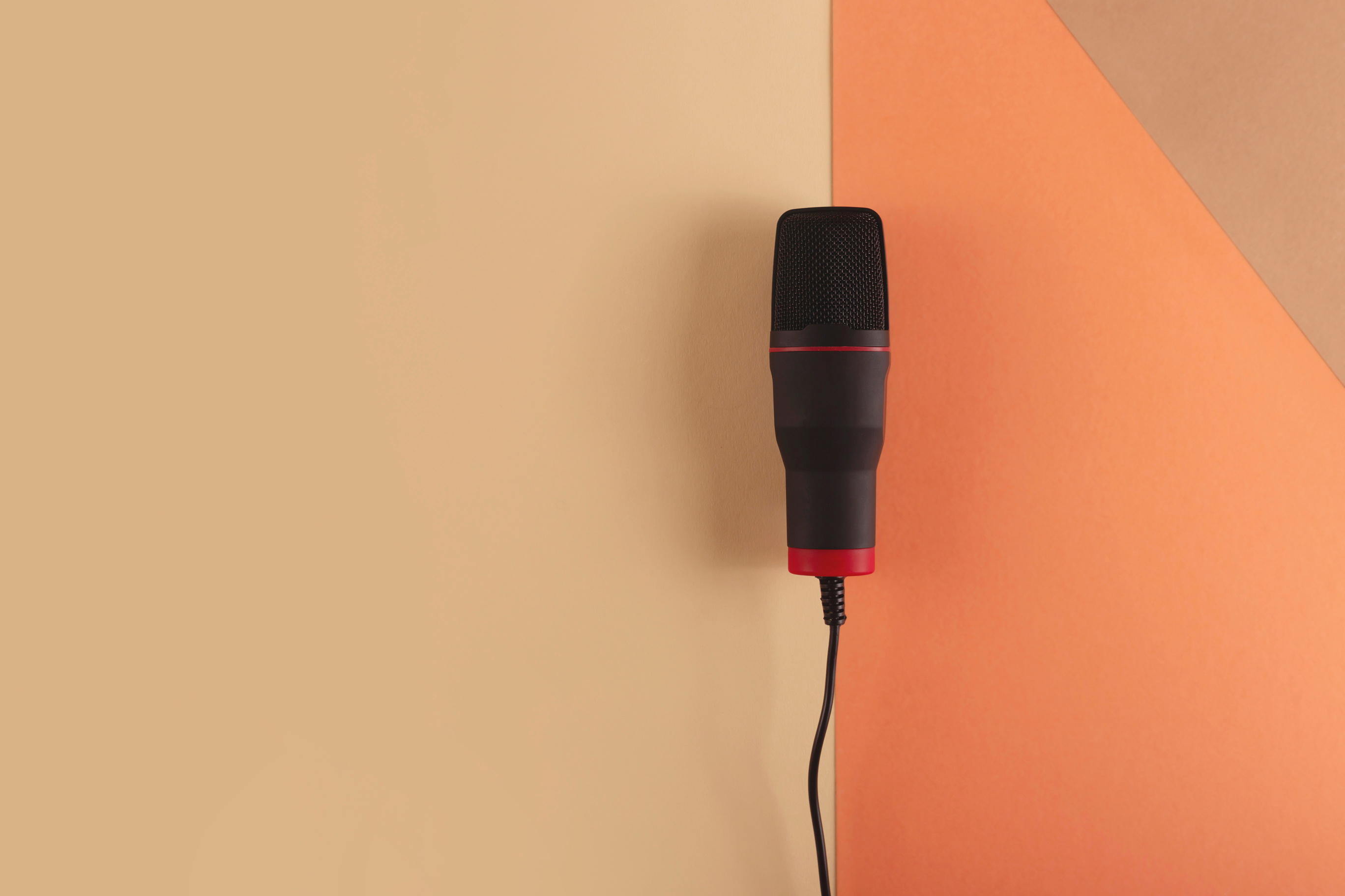 Microphone with Cord on Beige Background